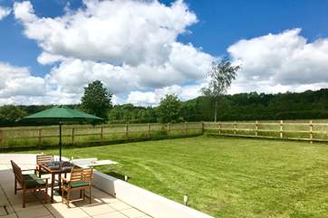 Two sets of doors open onto this wide paved terrace and the fully enclosed garden. The post and rail fencing also has rabbit proof wire and so is as secure as is reasonably possible.