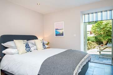 Both bedrooms have patio doors leading out to the lower terrace area.