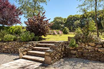 From the terrace area, steps lead up to the lovely lawned area.