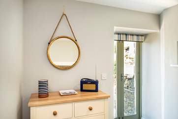 Double doors lead out from the bedroom to a lower terrace.