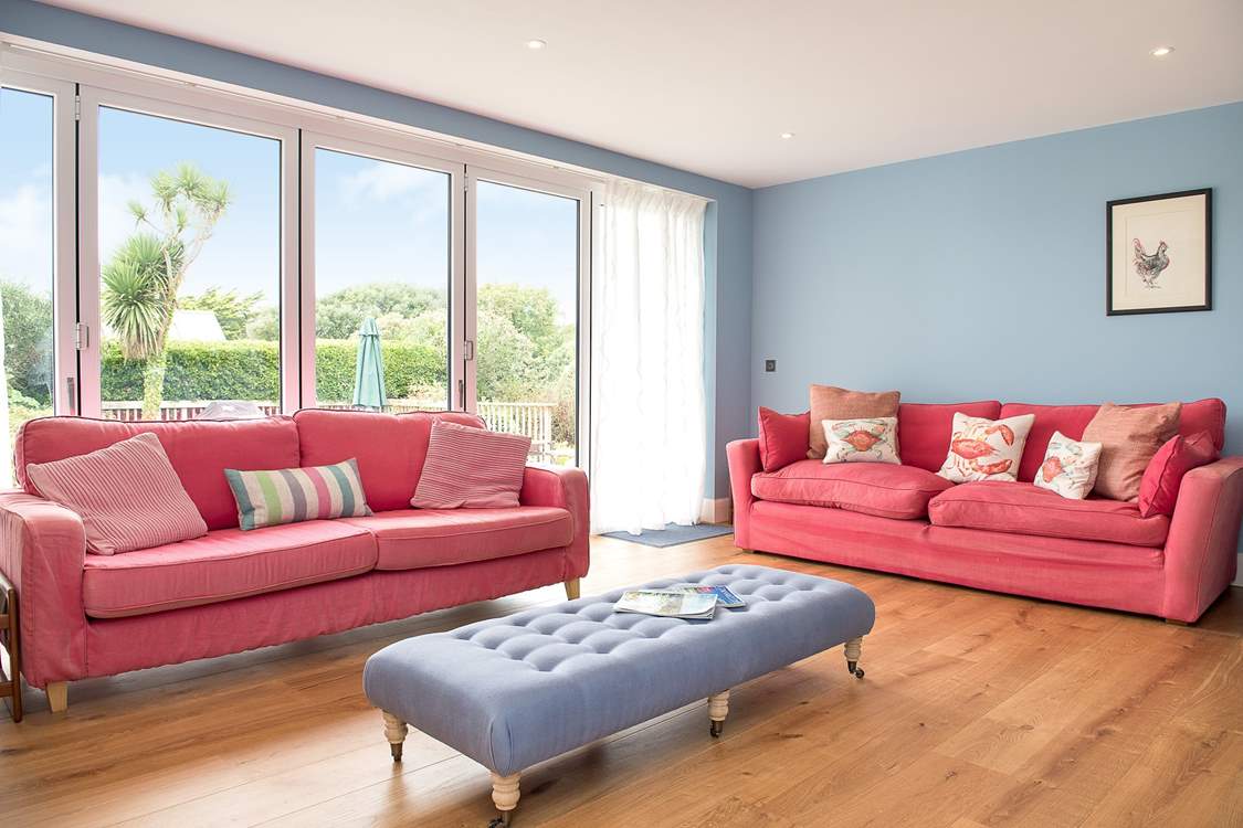 The bi-fold doors from the sitting-room open up to the garden.