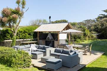 The fabulous decked area of the garden is home to an outdoor kitchen complete with pizza oven and barbecue.