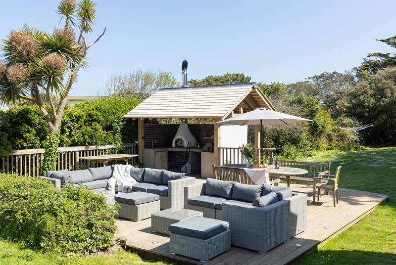 The fabulous decked area of the garden is home to an outdoor kitchen complete with pizza oven and barbecue.