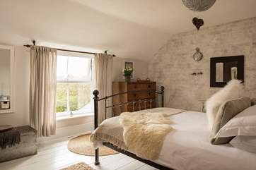 The gorgeous main bedroom, has a step leading down into it.