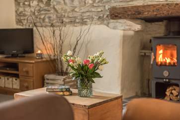 The snug sitting-room has a toasty wood-burner to snuggle up in front of.