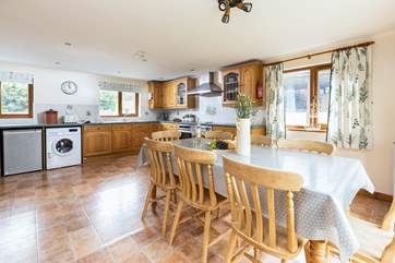 The kitchen is extremely spacious and well-equipped and floods with light.
