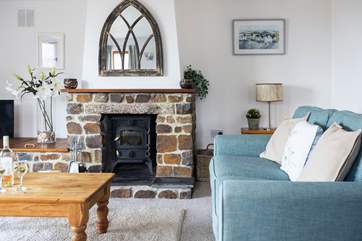 The wood-burner makes this inviting sitting-room the perfect place to snuggle up and enjoy a cosy night in.