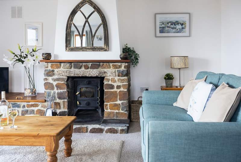 The wood-burner makes this inviting sitting-room the perfect place to snuggle up and enjoy a cosy night in.