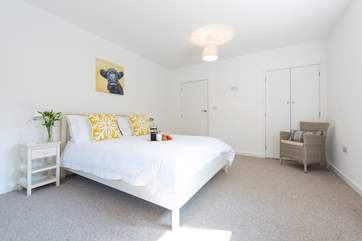 The master bedroom houses a king-size bed.