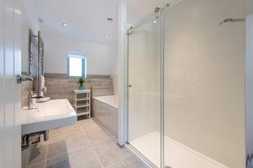 A nice big bath and a double shower in the family bathroom.