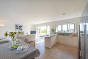 The kitchen area to the right, dining area to the left and the sitting area next to the French windows, allowing you to make the most of the sea views.
