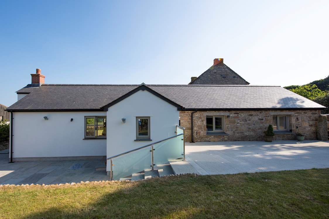 Six steps lead down to the front door from the parking area of this lovely barn conversion.