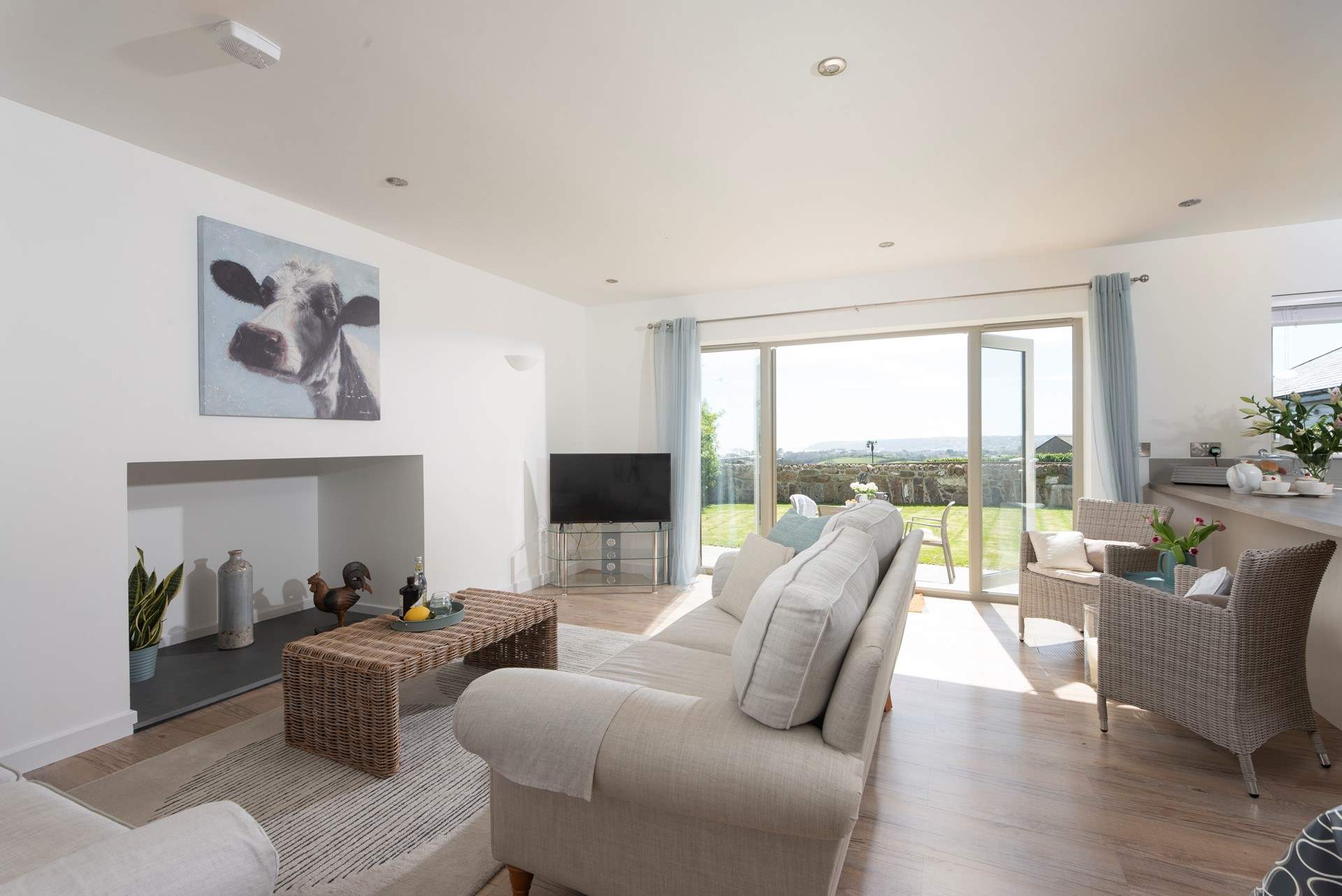 A comfortable deep sofa in the open plan living area with glorious sea views.