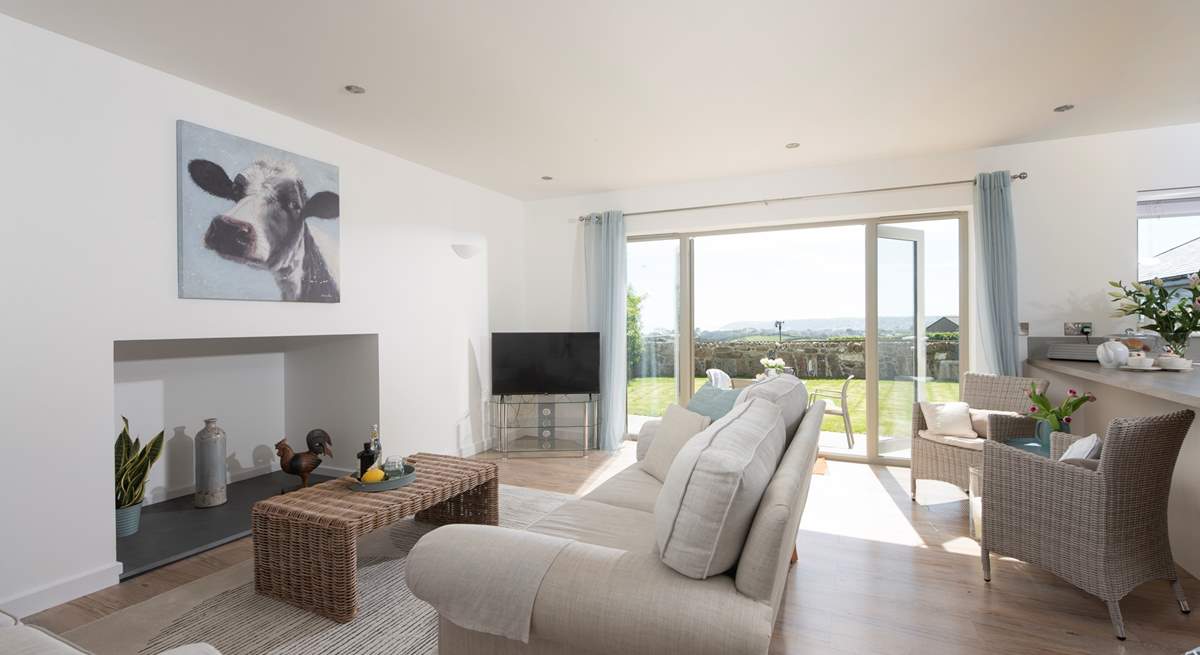 A comfortable deep sofa in open plan living area with glorious sea views.