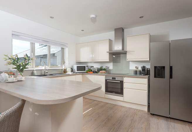 The modern well-equipped kitchen is a social space in the open plan living area to cook up a Cornish feast.