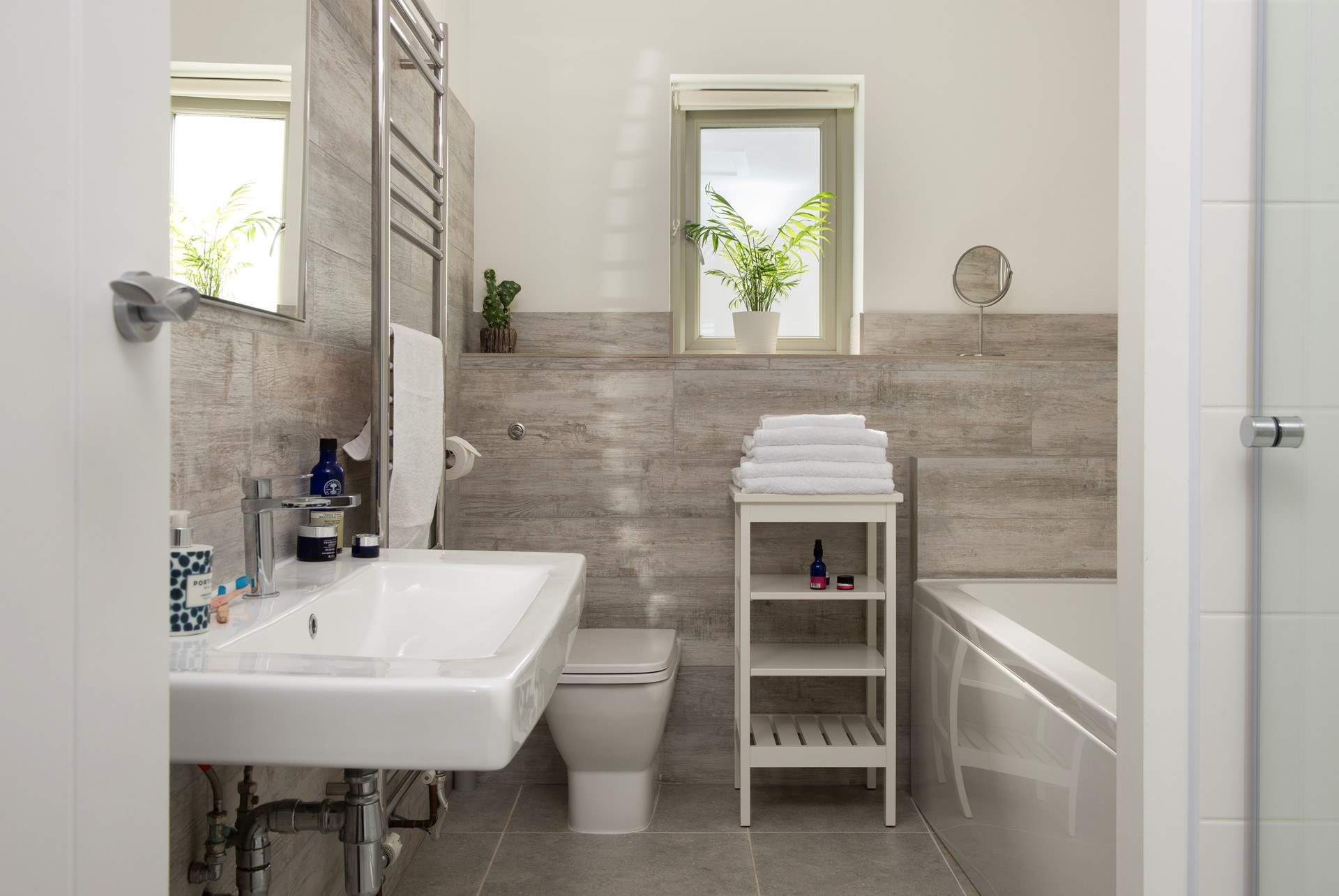The luxurious family bathroom with bath and power shower.