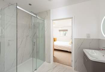 The beautiful en suite in bedroom 1 has stunning marble tiling.