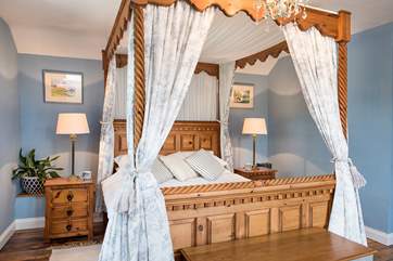 Bedroom one has a stunning four-poster bed.