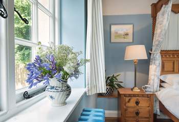 The bedroom overlooks the patio and gardens