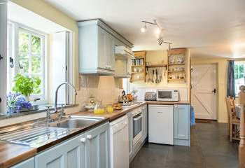 Soft shades of pale blue in the pretty cottage kitchen.