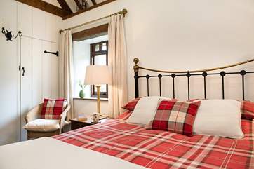 The bedroom has a gorgeous bedstead.