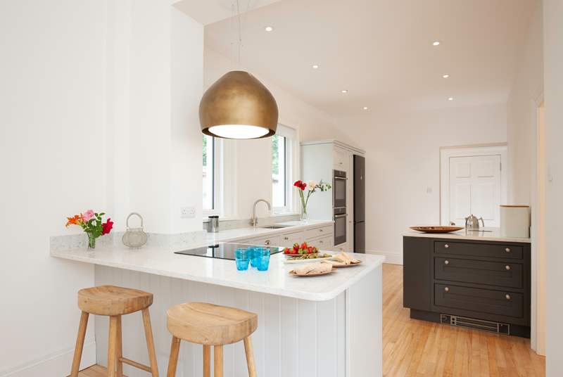 The open plan kitchen/dining-room has views looking out to the garden.