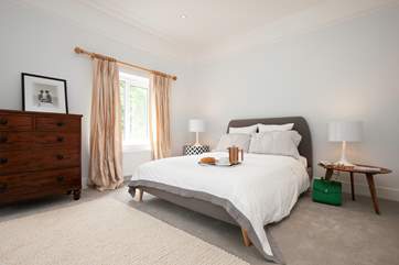 The master bedroom is very stylish with views over the rear garden.