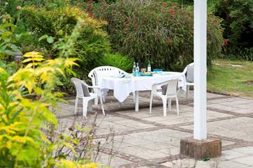 The patio wraps around two sides of the house.
