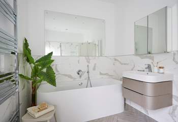 Lie back and relax in style in the family bathroom.