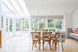 There is a lovely large dining-table with views of the garden for all to enjoy mealtimes together.