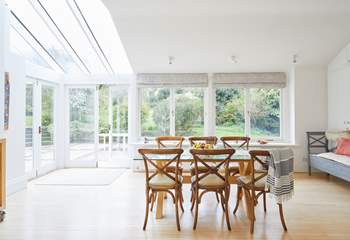 There is a lovely large dining-table with views of the garden for all to enjoy mealtimes together.