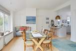 The open plan kitchen/dining-room has views looking out onto the garden.