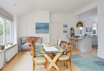 The open plan kitchen/dining-room has views looking out onto the garden.