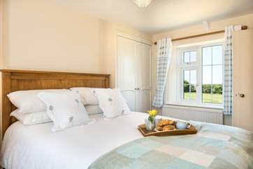 Bedroom one is double aspect looking out onto the courtyard and the meadow
