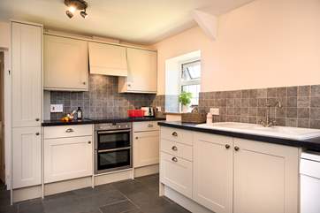 The modern kitchen is very stylish and well-equipped