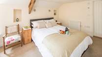 The principal bedroom is home to this exceptionally inviting king-size bed.