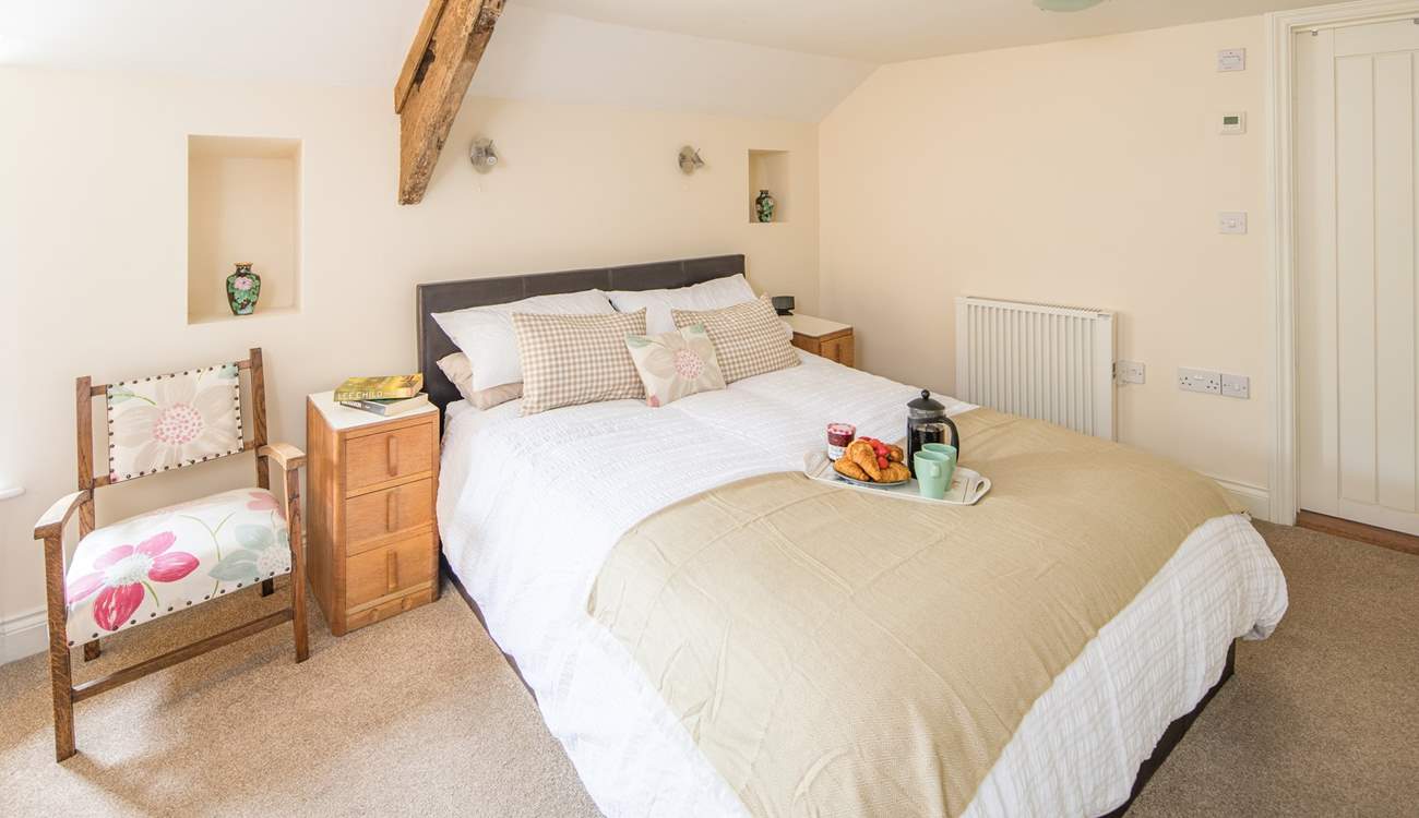 The principal bedroom is home to this exceptionally inviting king-size bed.