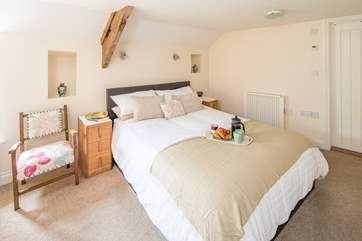 The master bedroom is home to this exceptionally inviting king-size bed.