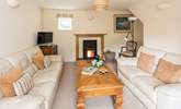 The comfortable sitting-room also has a wood-burner, which is perfect for those cosy nights in. - Thumbnail Image