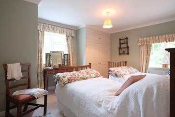 Bedroom 4 has twin beds and a wash-basin.