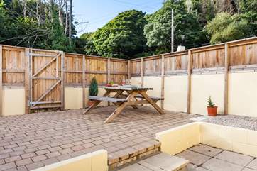 The outside area has a picnic bench for al fresco dining.