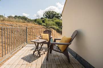 The balcony overlooks the enclosed rear garden area