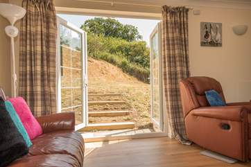 Double doors from the living area to the secure rear garden
