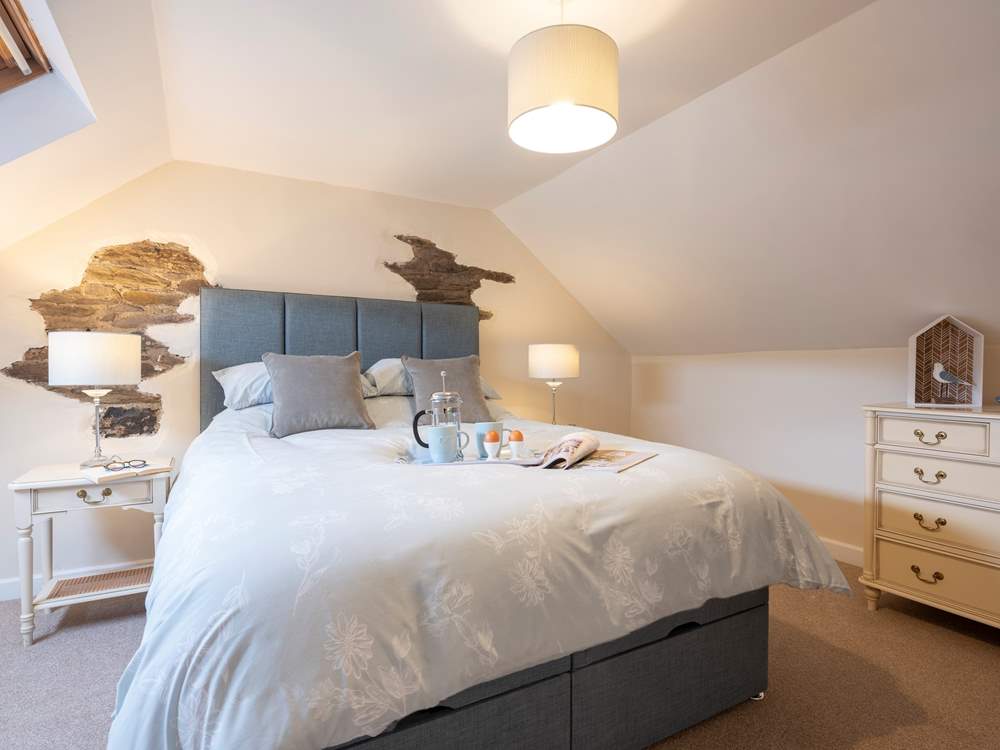 The bedroom is in the eaves and has sloping ceilings.