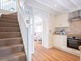 The stairs lead up to the open bedroom.