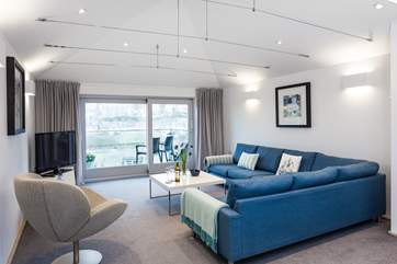 The sitting-room is the perfect place to relax and enjoy the view of St Ives. There is a small step leading up to the sitting-room.