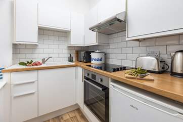The bright kitchen may be small but is equipped with all you will need for your stay at Lowenna.