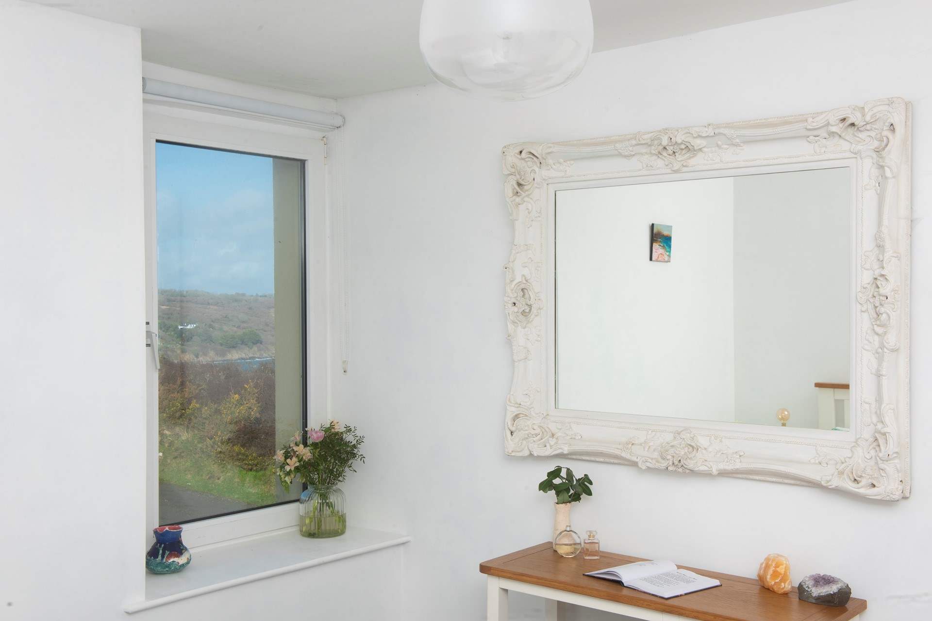 The bedroom boasts a glimpse of the bay.