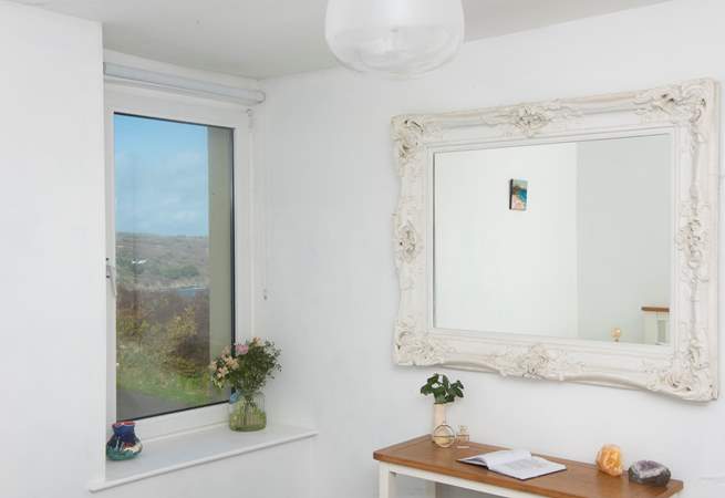 The bedroom boasts a glimpse of the bay.