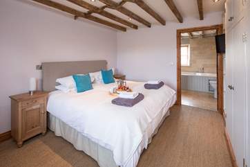 The master bedroom links through to a rather extravagant en suite bathroom.